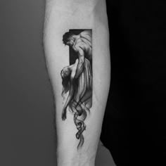 a black and white photo of a woman's arm with a cross on it