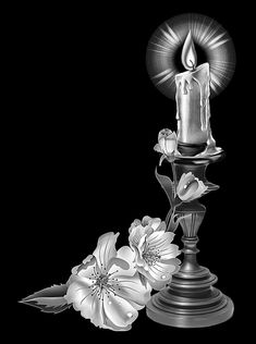 a candle and flowers on a black background