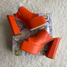 Brand New, Never Used Only Tried On In Store. Size Is 9.5 But Fits A 9-9.5, I’m A 9 And They Fit Me! Fall In Luv With The The Luna Luv Platform Mule In Orange! These Chunky Open-Toe Platforms Are Both Playful And Elevated, And Pair Perfectly With Any Flare Style Pant. Pair It With A Light Washed Jean For A Daytime Look Or Channel Your Y2k Vibes And Pair Them With Your Favorite Mini Skirt! Faux Leather Upper With Manmade Sole Slip-On Styling Leather Lining Approx 5.25 Inch Heel Approx 2 Inch Plat Modern Spring Heels With Round Toe, Orange Platform Heels With Closed Toe, Orange Platform Heels With Round Toe, Fall Open Heel Platform Heels, Modern Orange Open Toe Heels, Bold Platform Wedge Heel Heels, Bold Platform Wedge Heels, Bold Platform Heels With Wedge Heel, Trendy Orange Wedge Heels