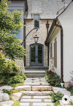 a stone walkway leads up to the front door of a house