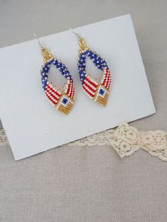 Jewelry Beads Earrings Beaded America Earrings US Flag Red White Blue Flag of America July 4 Independence Day Handmade Earrings are made of Czech beads with a design of the America flag. Red white and blue flag of America. USA 4 July Independence Day. Handmade Length of earring 6 cm, width - 3 cm If you have any questions, please contact me. Thank you for your interest in my work. Thank you for watching. Take a look at my other products https://www.etsy.com/listing/563124805/jewelry-beaded-set-american-bracelet-and?ref=shop_home_active_26 https://www.etsy.com/listing/590126508/jewelry-bead-necklace-beaded-american?ref=shop_home_active_1 Patriotic Multicolor Dangle Jewelry, Patriotic Blue Beaded Earrings, Blue Jewelry For 4th Of July Beach Day, Patriotic Adjustable Dangle Jewelry, Patriotic Beaded Dangle Earrings, Patriotic Blue Beaded Earrings As Gift, Patriotic Dangle Beaded Earrings, Patriotic Round Beads Jewelry Gift, Patriotic Drop Earrings Jewelry Gift