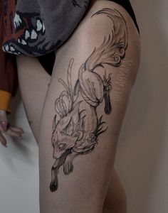 a woman with a tattoo on her thigh