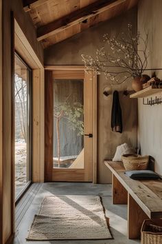 an entry way with a bench and rugs on the floor