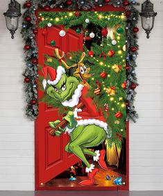 the grinch door cover is decorated with christmas decorations and lights, as well as an elf