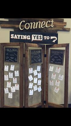 a room divider with writing on it and notes attached to the sides, in front of a sign that says connect saying yes to