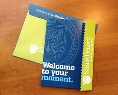 two blue and yellow tickets sitting on top of a wooden table