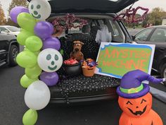 a car trunk filled with halloween decorations and balloons