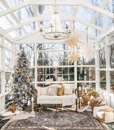 a living room filled with furniture and a christmas tree in the middle of the room