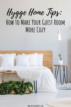 a bedroom with white walls and black lettering that says hygge home tips how to make your guest room more cozy