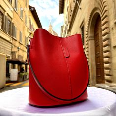 This bag has been made of the best genuine leather by local master crafters of Florence in Italy, designed for women who only accept premium Italian quality and luxury leather bags and modern Italian fashion. . Size: Width: 27 cm / 10.75 inches Height: 19 cm / 7.50 inches Depth: 9 cm / 3.50 inches Color: Red . The story of this bag : In the heart of Italy, where the art of leather craftsmanship thrives, a team of dedicated artisans creates masterpieces that transcend time and fashion. Among their creations is a breathtaking piece that stands as a symbol of beauty, quality, and elegance - the Italian Red Leather Tote. Handcrafted with meticulous precision and passion, this exquisite red tote is a prime example of Italian excellence. It embodies the essence of classic design, boasting a time Leather Hobo Bag For Business, Textured Leather Bucket Bag For Office, Classic Bucket-shaped Bag With Leather Lining, Classic Bucket Shaped Bag With Leather Lining, Formal Leather Bucket Bag, Elegant Bucket Shape Bag With Leather Lining, Red Business Bag With Smooth Grain, Smooth Grain Bucket Bag For Business, Elegant Soft Leather Bucket Hobo Bag