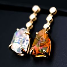 Asymmetrical Mexican Fire Opal Diamond Drop Earrings 18K Yellow Gold. Free Domestic USPS First Class Shipping! Free One Year Limited Warranty! Free Gift Bag or Box with every order! Opal—the queen of gemstones, is one of the most beautiful and rarest gemstones on earth. Every piece of opals has its colors and patterns, which is perfect for designers to create unique engagement rings for someone extra special. We use 100% Natural & Ethical opal stones (NO synthetics or imitations) for our jewelry. --------------------------------------------------------------- ABOUT THIS PRODUCTSolid 18k Yellow GoldMexican Fire Opal, 2.4 ct6 Diamonds: 0.054 ctEarrings Size: 20x7 mmOpal Size: 9x7 mmOccasion: Birthday/Anniversary/Engagement---------------------------------------------------------------------- Rarest Gemstones, Opal Promise Ring, Rings For Couples, Opal Drop Earrings, Australian Black Opal, Opal Birthstone, Promise Rings For Couples, Mexican Fire Opal, Rare Gemstones