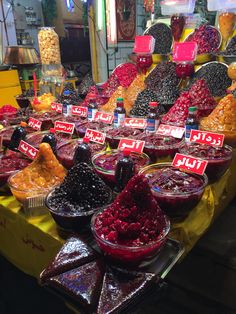 many different kinds of jelly on display at a market