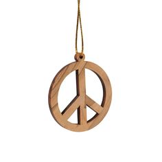 a wooden ornament with a peace sign hanging from it's side on a chain