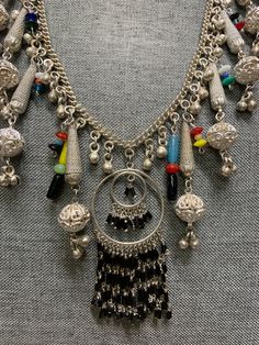 vintage funky handmade bohemian chic silver plate necklace. I have recyceld this beautiful old siver plate necklace that was made in the 1960's giving it a great bohemian chic look and a slight splash of color. The necklace is metal and silver plate and the beads are hand made glass. the necklace measures about 24 inches and is quite large with all its adonrnments. please note most of the vintage jewelry in the is section has been rescued recycled or repaired. which means they may have small alt Multicolor Metal Beaded Necklaces, Silver Bohemian Necklace For Festivals, Bohemian Silver Necklace For Festival, Multicolor Beaded Metal Necklaces, Vintage Necklace With Dangling Beads For Party, Bohemian Metal Beaded Necklaces With Large Beads, Bohemian Metal Jewelry With Large Beads, Multicolor Metal Beaded Necklaces For Party, Vintage Silver Beaded Necklaces For Festive Occasions