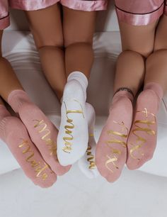 three girls in pink and white socks with gold lettering on them