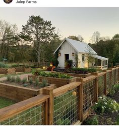 a fenced in garden area with lots of plants