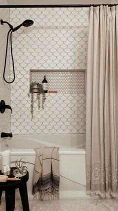 a bath room with a toilet and a shower head mounted to the side of a wall