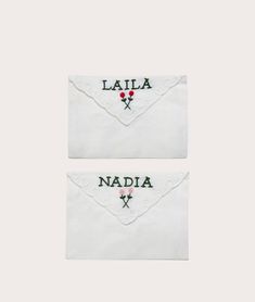 two embroidered napkins with roses on the front and back, both in white linen