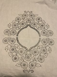 a black and white drawing of flowers on a piece of cloth