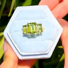 💎 Product Detail: *Metal: 14K Solid Gold *Gemstone:    - **Peridot     - Cut: Emerald-Cut      - Color: Green      - Clarity: Eye-Clean      - Size: 1 Piece 7 x 9 mm, 2 Pieces 5 x 7 mm      - Total Carat Weight (CTW): 5.00 *Diamonds:    - Color: Gold    - Clarity: VS    - Total Carat Weight (CTW): 0.03 💓 Why You'll Love It: The Fortune Olive Green Peridot Three Stone Ring is a stunning blend of vibrant color and timeless elegance. Featuring a central 7 x 9 mm emerald-cut peridot flanked by two 5 x 7 mm emerald-cut peridots, this ring creates a captivating triad of rich green stones. The 14K solid gold band adds a luxurious touch, while the sparkling diamonds enhance the overall elegance of the piece. This ring symbolizes prosperity, harmony, and eternal love, making it an ideal gift for Green Citrine Gemstone Rings, Green Multi-stone Gemstones In 14k Gold, 14k Gold Green Gemstones, Green Three Stone Peridot Jewelry, Green Peridot Three Stone Jewelry, Green Citrine Rings With Accent Stones, Green 14k Gold Gemstones With Accent Stones, Green Three Stone Gemstones For Anniversary, Diamond Three Stone Ring