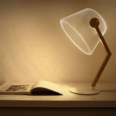 a lamp that is sitting on top of a table next to a book and magazine