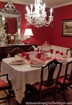 the dining room table is set with pink dishes and place settings for two people to eat