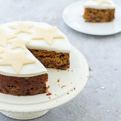 a piece of cake with white frosting and stars on top is sitting on a plate