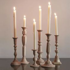 five candles are lined up on a table