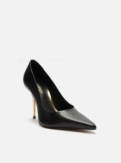 Black pump. The style features a high stiletto heel and a pointed toe. It is closed with a rounded cutout on the upper over the instep, and a snug fit on the sides. With an insole in the same color as the sandal and the brand name engraved, it shows the instep. Why follow this trend? The iconic Emily High Stiletto Pump lengthens the leg and boosts your confidence with each powerful stride. The ultra-luxe leather and the pointed toe exude effortless sophistication. Get ready to fall in love with Golden Heels, Luxe Style, Stiletto Pumps, Black Pumps, Leather Pumps, Leather Slip Ons, Stiletto Heel, Snug Fit, Stiletto Heels