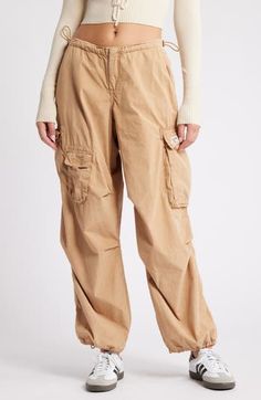 These Y2K-inspired cargo pants feature a baggy low-rise silhouette, plenty of pockets and a toggle-adjustable waist. 29 1/2" inseam; 12" leg opening; 10" front rise; 14 1/2" back rise (size medium) Exclusive retailer Zip fly with hook-and-bar closure Drawcord-toggle waist Front slant pockets; back patch pocket; cargo flap-patch and flap-bellows pockets 100% cotton Machine wash, line dry Made in Turkey Utility Parachute Pants With Flap Pockets, Baggy Mid-rise Cargo Parachute Pants, Mid-rise Relaxed Fit Cargo Parachute Pants, Fall Cargo Style Mid-rise Parachute Pants, Fall Mid-rise Cargo Style Parachute Pants, Fall Mid-rise Cargo Parachute Pants, Utility Full Length Parachute Pants For Fall, Utility Style Full Length Parachute Pants For Fall, Utility Full-length Parachute Pants For Fall