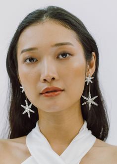 The Estee Earring is one of our all-time best-selling earrings, and it's obvious why: these stars are a sleek finishing touch for any look. Each twinkling star consists of many glass crystals, which are painstakingly prong-set by hand in a process that creates the most possible light-reflecting sparkle. Despite their considerable size, these earrings are surprisingly lightweight and comfortable to wear for hours, since they are made by hand rather than being cast in a mold. Dimensions: 3.25 x 1. Luxury Hair Accessories, Bridal Earrings Drop, Jennifer Behr, Jennifer Fisher, Wedding Bridal Jewellery, Luxury Hair, Fashion Shoot, Wedding Earrings, Bridal Earrings