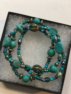 SALE! Was 18.00 now 15.00. Beautiful three piece beaded stretch bracelet set in shades of turquoise and mossy green. Beads are lab created turquoise, glass, clay, resin and silver finish. 7 to 7 1/2" long. Handmade and a one of a kind set. A lovely gift or treat yourself! Comes with gift box. Handmade Turquoise Stretch Bracelet For Healing, Handmade Turquoise Bracelets With Czech Glass, Spiritual Beaded Turquoise Wrap Bracelet, Handmade Turquoise Czech Glass Bracelets, Spiritual Turquoise Beaded Wrap Bracelet, Spiritual Turquoise Beaded Stretch Bracelet, Turquoise Czech Glass Bracelets With Round Beads, Turquoise Czech Glass Bead Bracelets, Turquoise Czech Glass Round Beads Bracelet