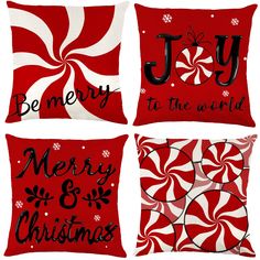 four red and white christmas pillows with black lettering