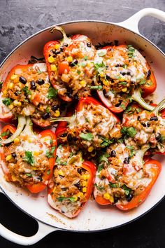 stuffed bell peppers in a skillet on a table