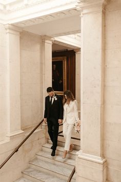 a bride and groom walking down the stairs at their wedding ceremony in washington, d c