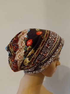 a mannequin head wearing a multicolored turban with flowers on it