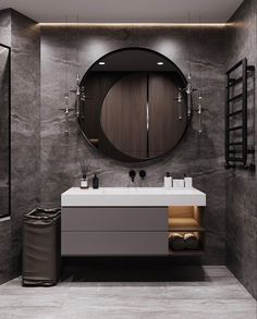 a bathroom with a round mirror above the sink