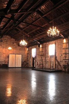 an empty room with chandeliers hanging from the ceiling