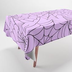 a purple table cloth with black lines on it and a spider web design in the center