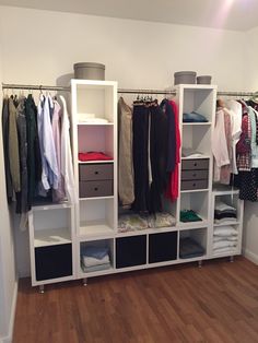 an image of a closet with clothes on shelves