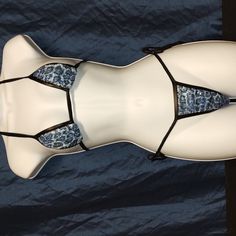 a white mannequin with blue and black laces on it's sides