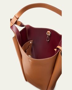 Tod's bucket bag in grained calf leather     Fixed top handles, 12.6" drop     Hook closure     Removable pendant with branded metal T Timeless accessory    Interior, two slip pockets     Lining: Leather/nylon/polyurethane    Approx. 12.6"W x H 11.8"H x 4.7"D    Made in Italy Luxury Tan Bucket Bag For Everyday Use, Luxury Tan Bucket Bag With Double Handle, Cognac Epsom Leather Bag With Palladium Hardware, Luxury Tan Double Handle Bucket Bag, Classic Bucket Hobo Bag With Detachable Handle, Classic Leather Bucket Bag With Detachable Handle, Classic Tan Bucket Bag, Classic Bucket Bag With Detachable Handle For Business, Classic Business Bucket Bag With Detachable Handle