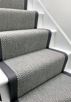 the stairs are decorated with black and white herringbone fabric, which matches the carpet