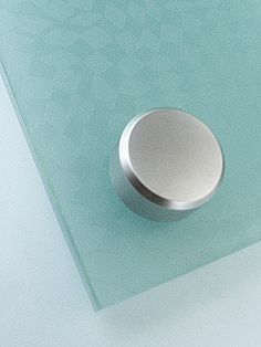 a round object is sitting on top of a glass table