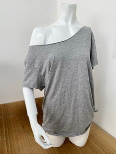 Off The Shoulder Slouchy T Shirt 100% Cotton Raw Cut Neck and Sleeves Traditional Hem  The off-the-shoulder cotton slouchy T-shirt is a piece that embodies both comfort and style. Handmade from 100% cotton fabric, it offers a natural and breathable feel. The raw cut neckline and sleeves, along with the traditional hem at the bottom, create a relaxed yet stylish look that can easily transition from casual outings to yoga or gym sessions. With availability in a wide variety of colors, this T-shirt provides options for individuals to express their personal style preferences. Its off-the-shoulder design adds an alluring touch while maintaining comfort, making it a versatile choice for different occasions. SIZE GUIDE USA XS fits US Sizes 4 Small Fits US Sizes 6 Medium Fits US Sizes 8 Large Fits Off The Shoulder T-shirt, Off The Shoulder Outfit Casual, No Sleeves Shirt, Loose Off The Shoulder Top, One Shoulder T Shirt, Off Shoulder T-shirt, Basic Clothes For Women, How To Make A Off Shoulder Shirt, Shirt Under T Shirt Outfit