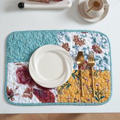 a place mat that has some plates and silverware on it