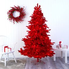 a red christmas tree in a white room