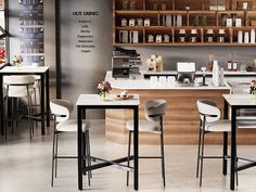 a kitchen with lots of counter space and chairs