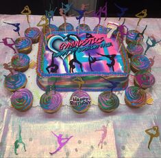 a birthday cake decorated with cupcakes and colorful icing