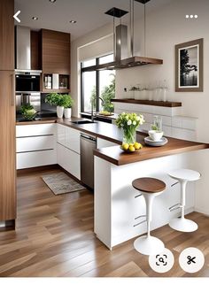 an image of a kitchen setting with white cabinets and wood flooring on the walls